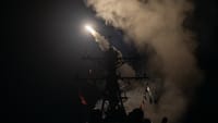 A Tomahawk cruise missile is being launched from a ship at night over the Red Sea