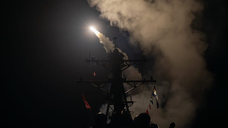 A Tomahawk cruise missile is being launched from a ship at night over the Red Sea